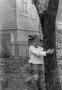Photograph: [Child Hugging a Tree]