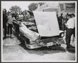 Photograph: [Bystanders View a Wrecked Car with Raised Hood]