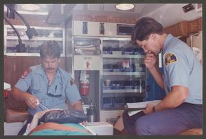 Primary view of object titled '[Two Paramedics Work on Patient]'.