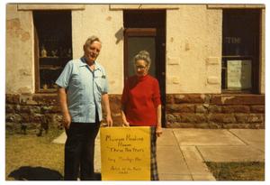 Primary view of object titled 'James Lovelady and Nora Bell Munn in front of Clark Hotel Museum'.