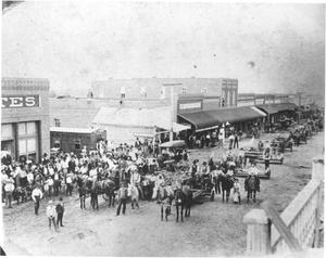 Primary view of object titled 'Wagons Passing Down Main Street'.