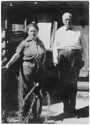Primary view of object titled '[Col. Hugh B. and Helen Moore in front of their cabin in New Mexico]'.