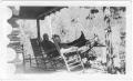 Photograph: [Col. Hugh B. and Helen Moore relaxing on the porch of their ranch]