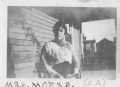 Photograph: [Mrs. C. A. Moers sitting in a chair on a porch]