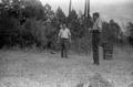 Photograph: [Everett Barrilleaux and Jack Lewis Playing Horseshoes]