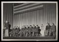 Photograph: [Sympson Speaking on Stage During Kingsbury Visit]