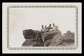 Photograph: [Four Soldiers on Rocky Outcropping]