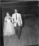 Photograph: [Couple Walking During County Fair Pageant]