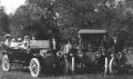 Photograph: [Family Photo with Two Cars]