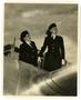 Photograph: [Lorna Lose & Judy Fuller Standing in Plane Cockpit]