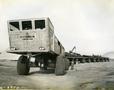 Photograph: Track-Less Land Train with pipe load P0U, P-10-34, L 6956