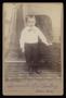 Photograph: [Portrait of an Unknown Boy Next to a Chair]