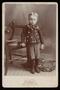 Photograph: [Portrait of a Young Boy Next to a Chair]