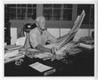 Photograph: [Fleet Admiral Chester W. Nimitz Sits at Desk in Headquarters]