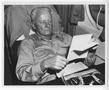 Photograph: [Fleet Admiral Chester W. Nimitz Reads a Document Aboard Plane]
