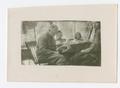 Photograph: [Chester W. Nimitz Reads at Table with Children]