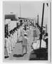 Photograph: [Enlisted U.S. Navy Men as U.S. Naval Officers Walk By]