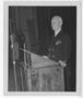Photograph: [Admiral Chester W. Nimitz Stands at Podium]