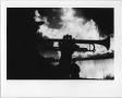 Primary view of [Trumpet player silhouetted against North Texas Homecoming bonfire, 1987]