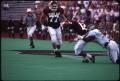 Photograph: [North Texas Football Player Tackles an Aggie, 1991]