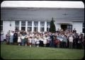 Photograph: [Photograph of Large Group in Front of White Building]
