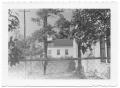 Primary view of [Side View of Man Standing in Front of Presbyterian Manse]