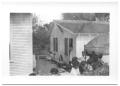 Primary view of [People Lined Up Outside of a House]