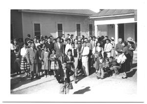 Primary view of object titled '[Hispanic Presbyterian Congregation Outside of a Church]'.