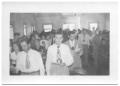 Photograph: [Front View of a Large Congregation Standing in Church Pews]