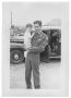 Photograph: [Henry Camacho in a Uniform Holding a Baby]