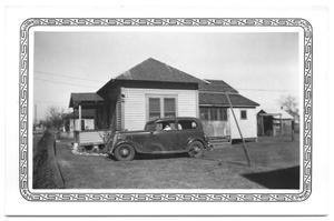 Primary view of object titled '[Car Parked in Front of the Side of a Building]'.