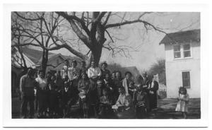 Primary view of object titled '[Group of Hispanic People Crowded Under a Crooked Tree]'.