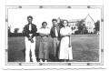 Photograph: [Four Hispanic People Standing in Front of a Large Estate]