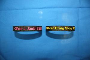 Primary view of object titled '[Image of two wrist bands honoring Officer Jillian Smith and Officer Craig Story]'.