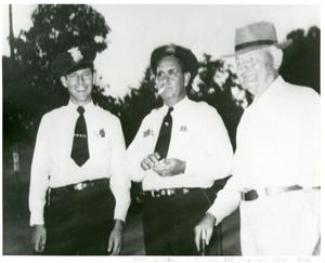 Primary view of object titled '[Arlington Police Officers Howard Vaughan and G.A. Coke with Ed Pummill, 1950]'.