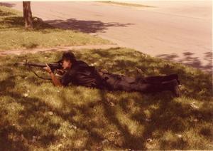 Primary view of object titled '[Arlington Police Officer Dick Hill, SWAT team training in prone firing position]'.