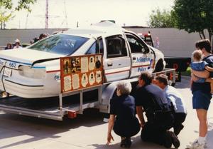 Primary view of object titled '[Arlington patrol car belonging to Officers Lewis and Crocker on display for MADD, 1992, passenger side view]'.