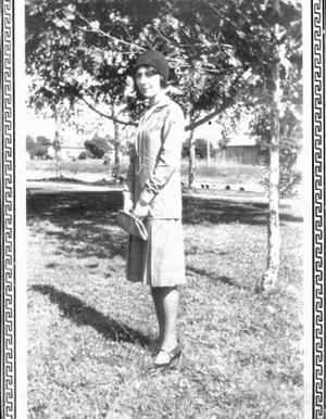 Primary view of object titled '[Emma Phillippi Miller, Rosenberg resident, standing in front of trees]'.