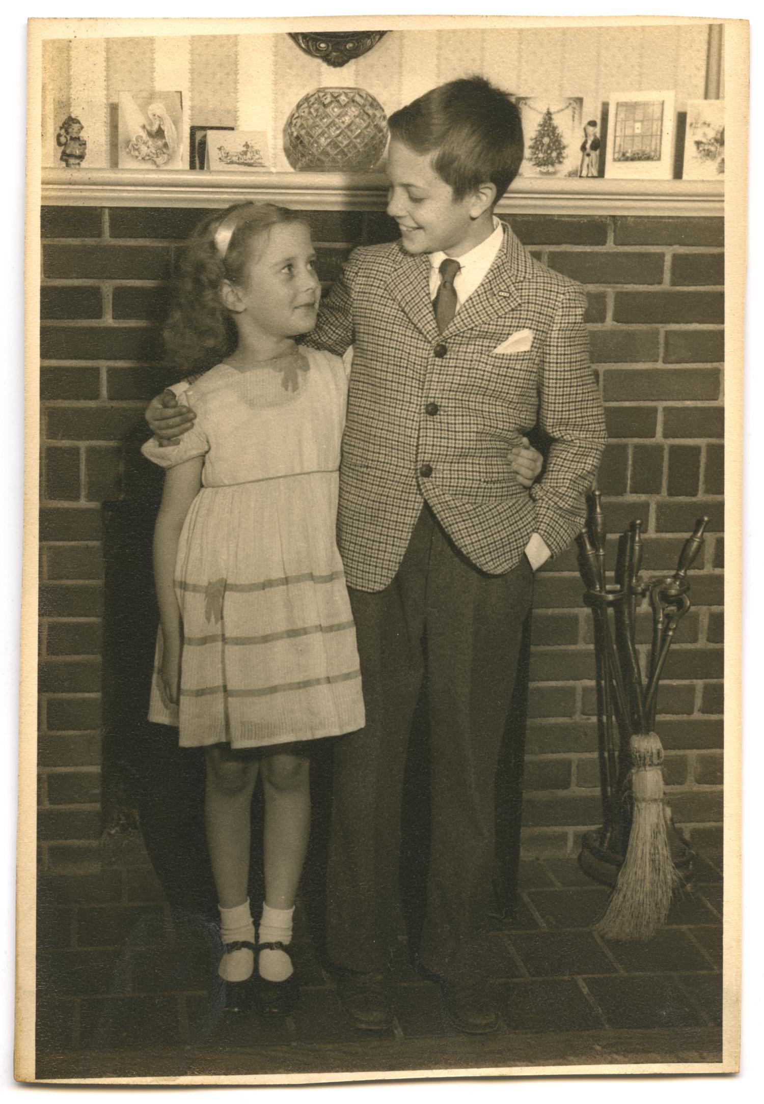 Photo of boy and girl in front of fireplace
                                                
                                                    [Sequence #]: 1 of 2
                                                