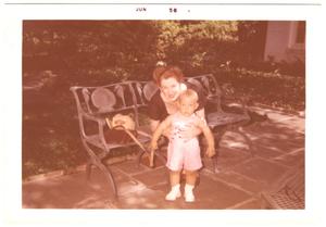 Primary view of object titled '[Lillie Abercrombie with toddler on patio bench]'.