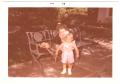 Photograph: [Lillie Abercrombie with toddler on patio bench]