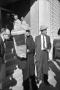Photograph: [Dallas Police detectives carrying evidence out of the Book Depositor…