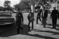 Photograph: [The "three tramps" being escorted to the Sheriff's office]