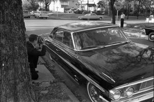 Primary view of object titled '[Car taking Jack Ruby's sister Eva Grant to the Dallas Police Department]'.