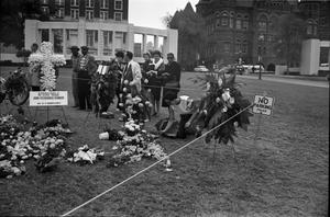 Primary view of object titled '[Crowd and memorial flowers in Dealey Plaza on November 27, 1963]'.
