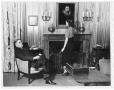 Photograph: [George A. Hill, Jr. with daughter Joanne standing by fireplace]