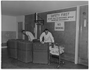 Primary view of object titled '[Men working inside workshop area]'.