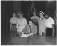 Primary view of [Governor Shivers signing document while women stand behind watching]