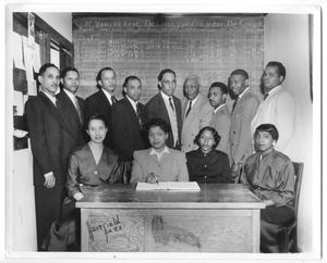 Primary view of object titled '[Group of Businesspeople in Front of Chalkboard]'.