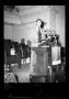 Primary view of [Photograph of a Man Standing Behind a Podium]